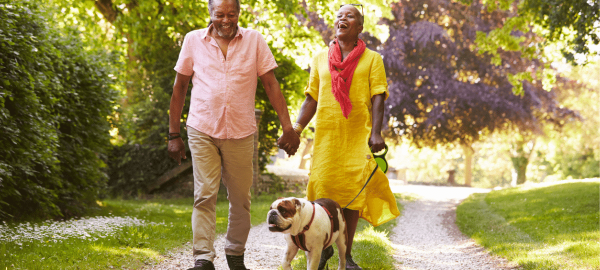 Older couple walking their dog