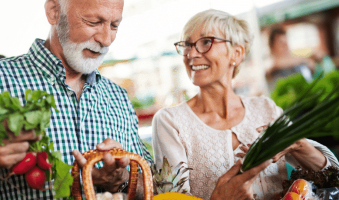 Older couple buy vegetables