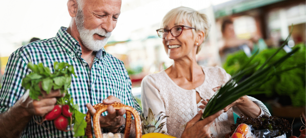 Older couple buy vegetables