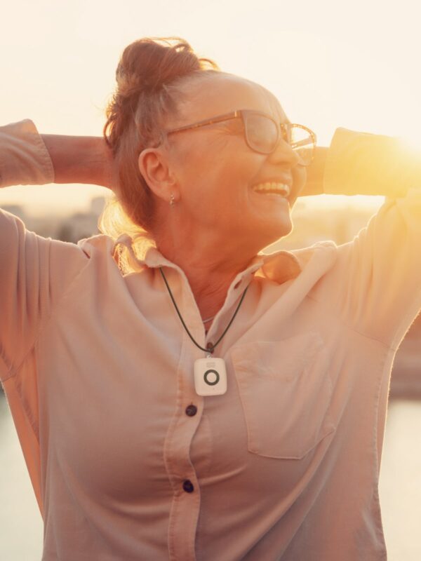 Woman at sunset wearing Medical Alert Mini Mobile System