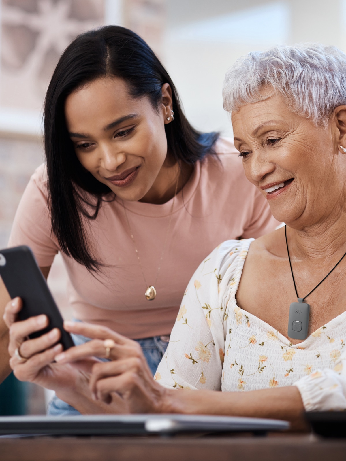 Woman wearing Medical Alert Mobile System uses Medical Alert mobile app