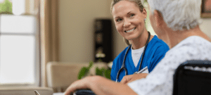 Friendly Nurse Talking To Senior