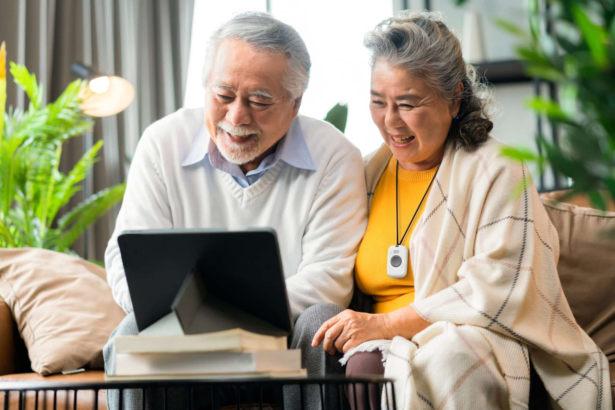 Elderly Couple with Help Button Video Call With Grandchildren