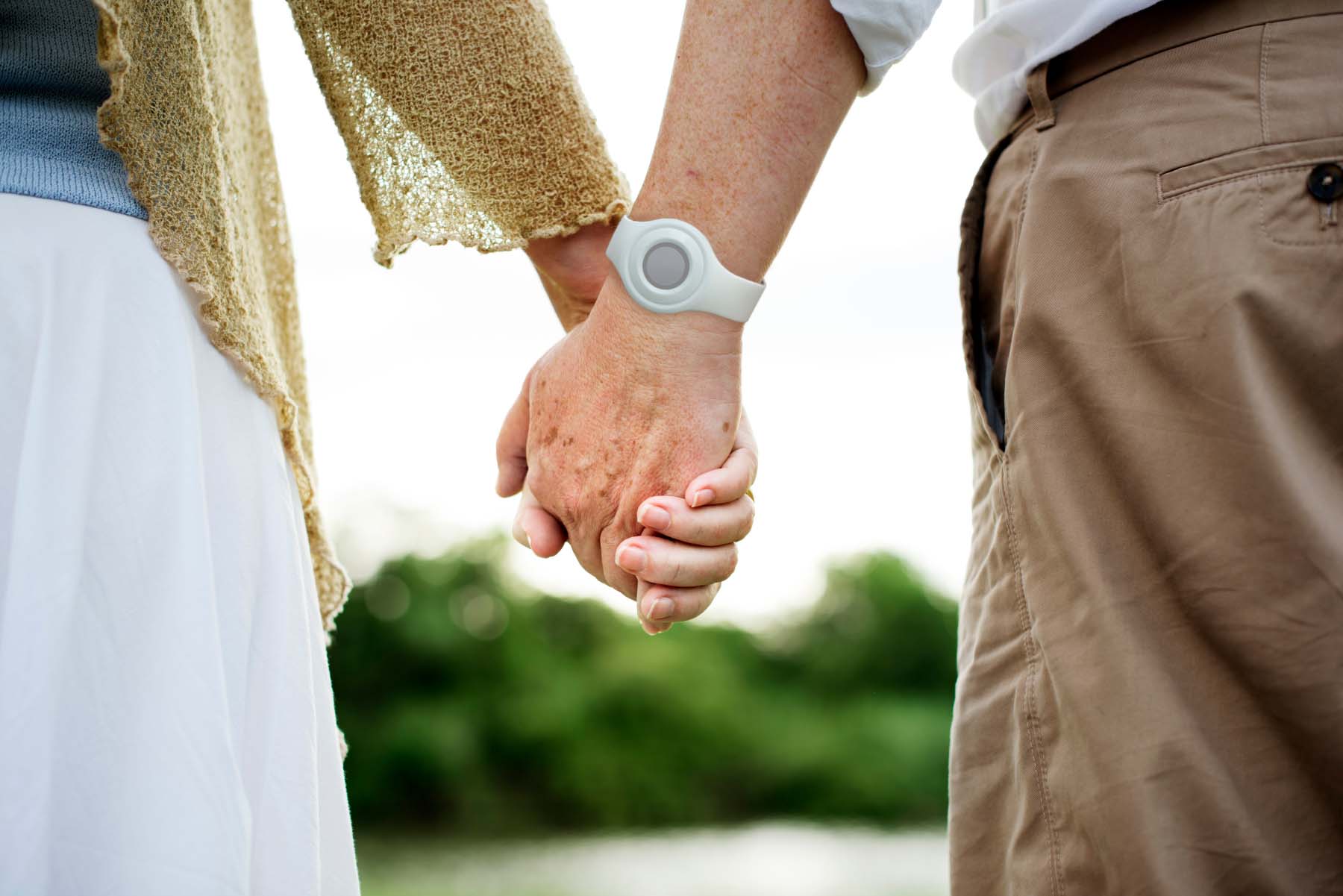 Holding hands, wearing wrist worn help button