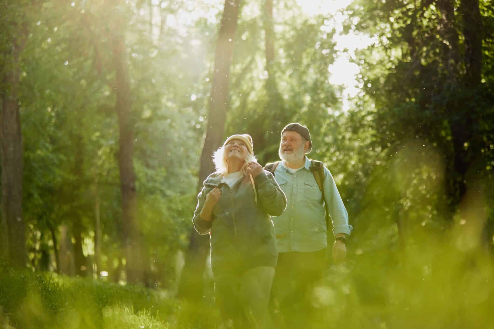 Older couple taking a morning walk outdoors during National Wellness Month