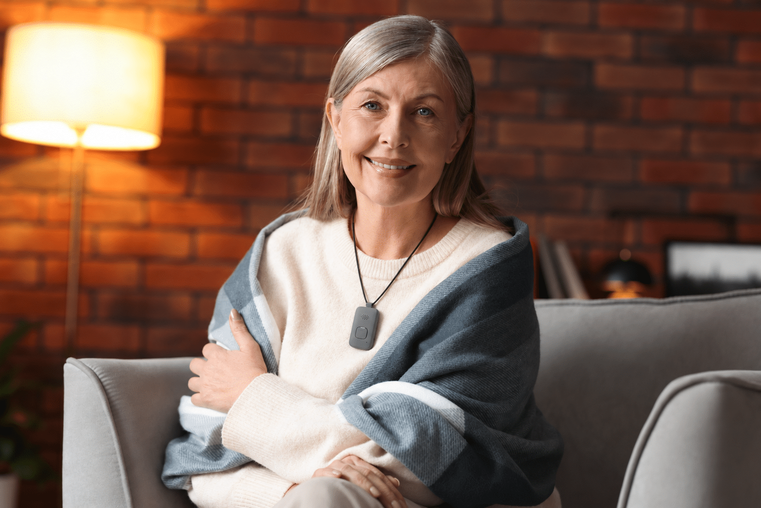 Senior woman wearing a medical alert necklace at home.